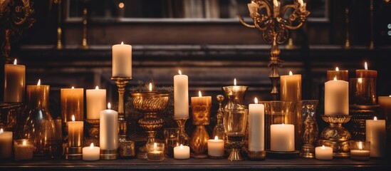 Fototapeta na wymiar In a dimly lit room of a historic building, a row of candles flicker on a metal fixture mantle, casting a warm glow and dispelling the darkness