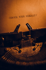 CHANGE YOUR MINDSET! typed words on a vintage typewriter. Close up. Antique Typewriter.