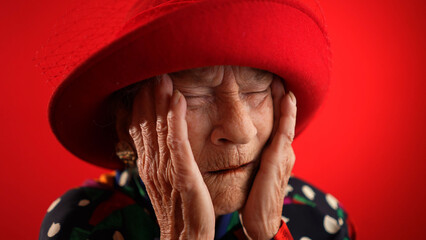 Funny portrait of sick tired headache migraine exhausted elderly mature old woman rubbing temples...