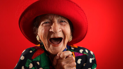 Saying WOW, a happy fisheye closeup portrait caricature of funny elderly woman with red hat...