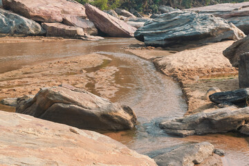 flow of Telwa river stream falling through levels of rocky terrain at Dharhara falls in Simultala, Bihar. Water level is knee-deep as flow of water is mostly dried-up in winter season.
