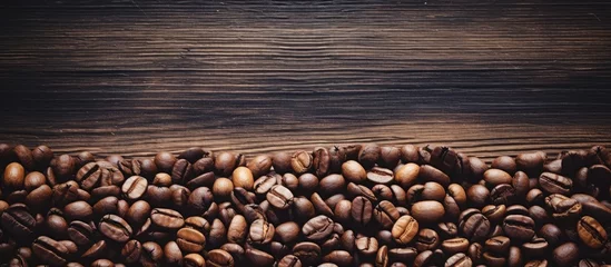 Raamstickers Aromatic Coffee Beans Scattered on Rustic Wooden Background for Gourmet Roasts and Barista Brews © Gular