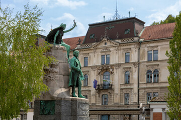 Ljubljana, Slovenia; Saint Nicholas's Cathedral (Katedrala Sv. Nikolaj) and sculpture located in Prešeren square (Prešernov trg) in front of Franciscan Church of the Annunciation