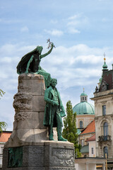 Fototapeta premium Ljubljana, Slovenia; Saint Nicholas's Cathedral (Katedrala Sv. Nikolaj) and sculpture located in Prešeren square (Prešernov trg) in front of Franciscan Church of the Annunciation