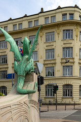 Naklejka premium Ljubljana, Slovenia; The Ljubljana Dragon Bridge spans the Ljubljanica River, Ljubljana Central Market and Saint Nicholas's Cathedral (Katedrala Sv. Nikolaj), dragon sculpture