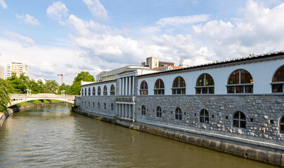 Naklejka premium Mesarski most, butcher's bridge, bridge with padlocks spans the promenade Ljubljanica River, with viewa to Ljubljana Central Market and Saint Nicholas's Cathedral and Ljubljana Castle, Slovenia