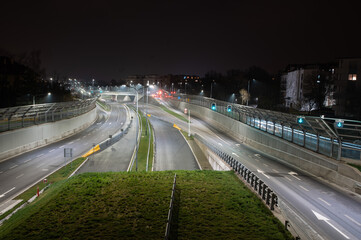 Highway in the city at night with cars on the road.
