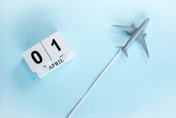 April calendar with number  1. Top view of a calendar with a flying passenger plane. Scheduler....