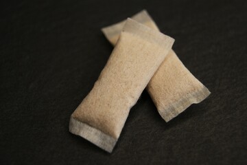 Two nicotine pouches on a dark background. High quality photo
