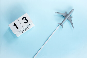 April calendar with number  13. Top view of a calendar with a flying passenger plane. Scheduler....
