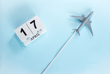 April calendar with number  17. Top view of a calendar with a flying passenger plane. Scheduler....