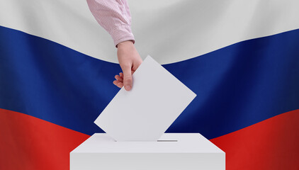 Elections, Russia. The concept of elections. A hand throws a ballot into the ballot box. Russian...