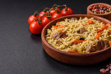 Delicious pilaf with vegetables, salt, spices and herbs in a ceramic plate
