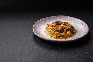 Delicious pilaf with vegetables, salt, spices and herbs in a ceramic plate