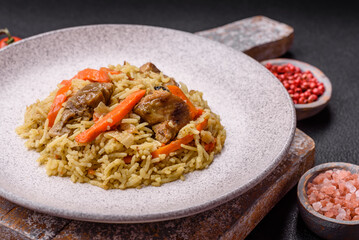 Delicious pilaf with vegetables, salt, spices and herbs in a ceramic plate