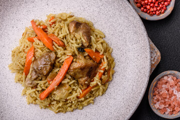 Delicious pilaf with vegetables, salt, spices and herbs in a ceramic plate