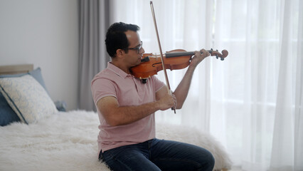 Man playing violin at home