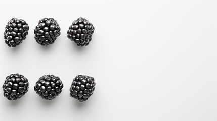  a group of blackberries sitting next to each other on a white surface with one blackberries in the middle of the picture.