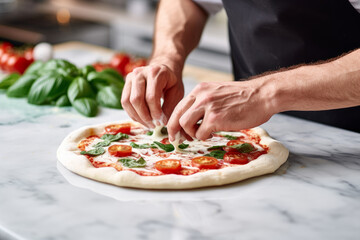 Male chef prepares pizza on a marble table