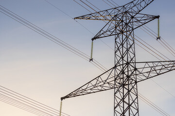 Closeup of a hydro tower and electrical lines.
