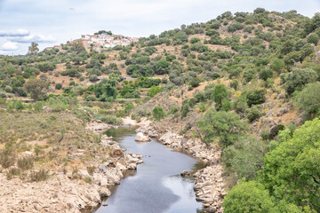 the Erges river with a view of Segura town, municipality of Idanha-a-Nova, province of Beira Baixa, Castelo Branco, Portugal - 758235270