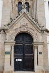 Entrance portal in carved stone with pantocrator iconography with closed doors of Our Lady of help church, Espinho PORTUGAL