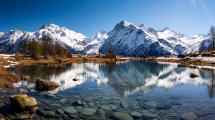 Fototapeta na wymiar Crystalclear lake with snow capped mountains in scenic view