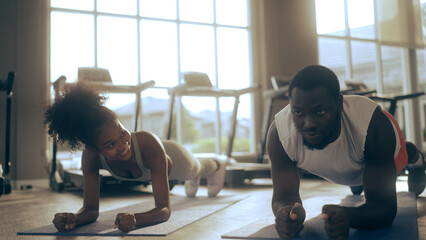 African American friends working out in the gym