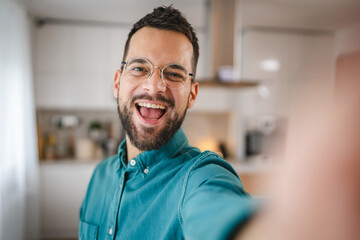 portrait of One adult man with eyeglasses stand at home happy smile