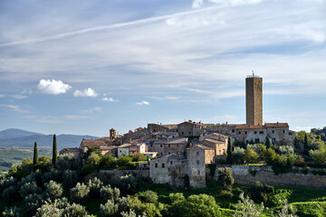stone houses, bell tower and medieval tower on top of a hill in the town of Pereta in Tuscany