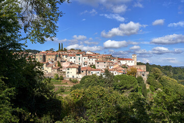 Fototapeta na wymiar stone houses and medieval church tower in Scansano village in Tuscany