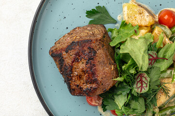 Portion of grilled beef mignon steak with vegetables