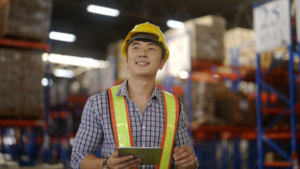 Warehouse workers use tablets to inspect products.