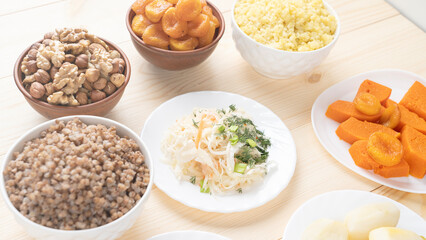 Holy Week, End, Palm Sunday, Good Friday, Easter Sunday Concept. Orthodox food in Great Christian Lent, Lenten food on a wooden table against the background of Orthodox icons.