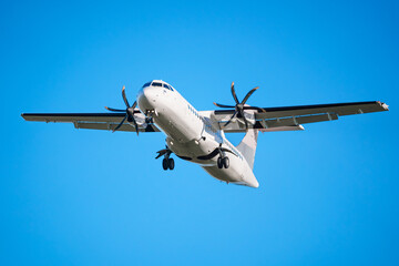 ATR 72 airplane, a twin-engine turboprop short-haul regional passenger aircraft. Landing airplane....