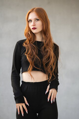 Portrait of a young beautiful red-haired girl outdoors.