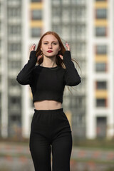 Obraz premium Portrait of a young beautiful red-haired girl outdoors.