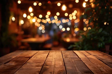 Fotobehang Image of wooden table in front of abstract blurred restaurant lights background. © Azar