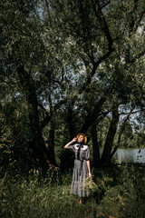 The image shows a person standing under a tree in an outdoor setting. 6329