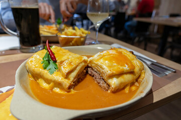 traditional delicious portuguese francesinha in a restaurant in Porto Portugal