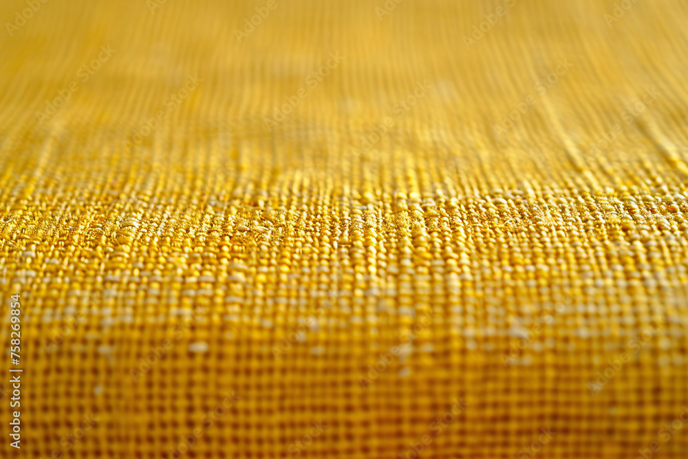 Poster macro view of golden fabric showing detailed weave texture