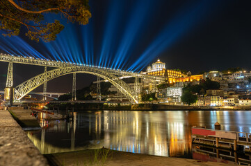 dom luiz brige lighht show in Porto on the riverside of Duero river cityscape at night - obrazy, fototapety, plakaty