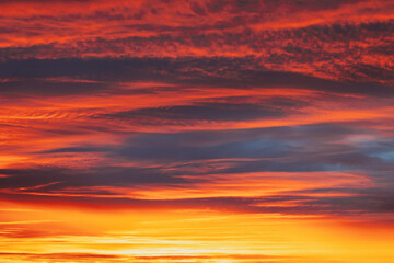 Abstract Saturated Orange-yellow Colors Of Clouds. Unusual Sky Background. Rich Orange Colors. Toned Pink-yellow Clouds. Sky Sunset Sunrise Background. Cloudy Sky. Sunny Cloudscape