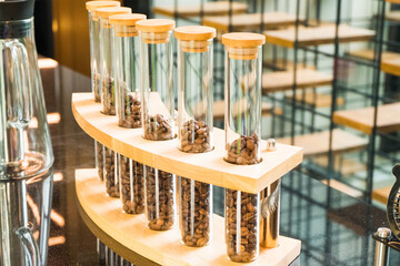 Close up coffee bean in test tube in small roastery.