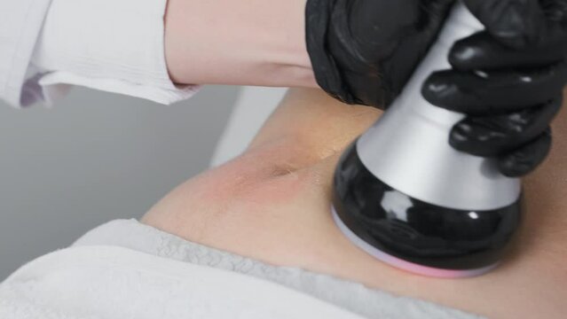 Client undergoes vacuum to facilitate removal of liquefied fat cells. Salon provides aesthetic techniques to achieve slimmer abdominal profile