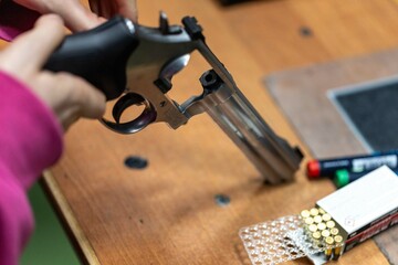Loading ammunition into a revolver - frame with ammunition - sports shooting range