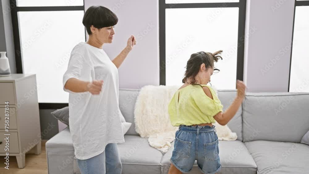 Sticker joyful mother and daughter confidently dancing together, radiating happiness in the living room of t