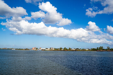 Background of beautiful white cloud and blue sky over the Mississippi River. The opposite is...