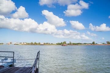 Fototapeta premium Background of beautiful white cloud and blue sky over the Mississippi River. The opposite is Algiers Point. The New Orleans Riverfront or the French Quarter River Walk is a nice spot to promenade the 