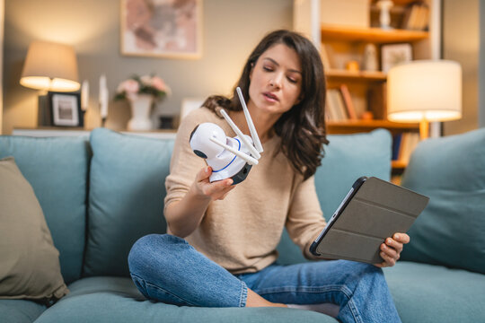 One woman use digital tablet to adjust install home security camera